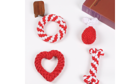 Set of four rope dog toys in red and white, including a ring, drumstick, heart, and bone shapes, for interactive chewing.